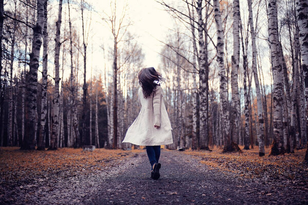 Portrait of cheerful girl in autumn park, outdoor