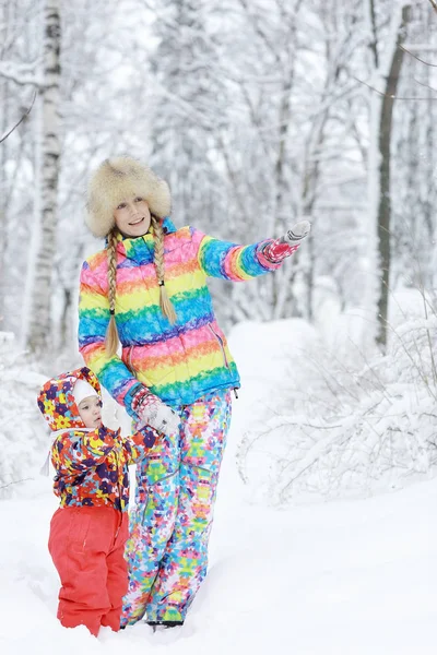 Dziewczyna z matką w snowy park — Zdjęcie stockowe