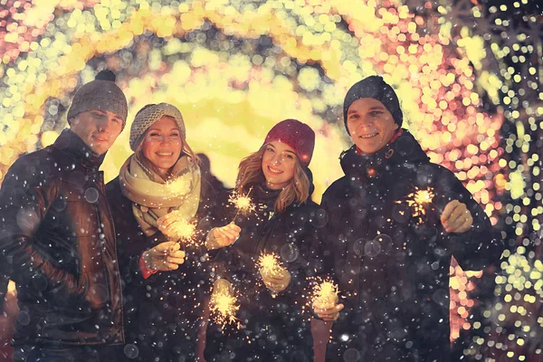 young people at city street with sparklers