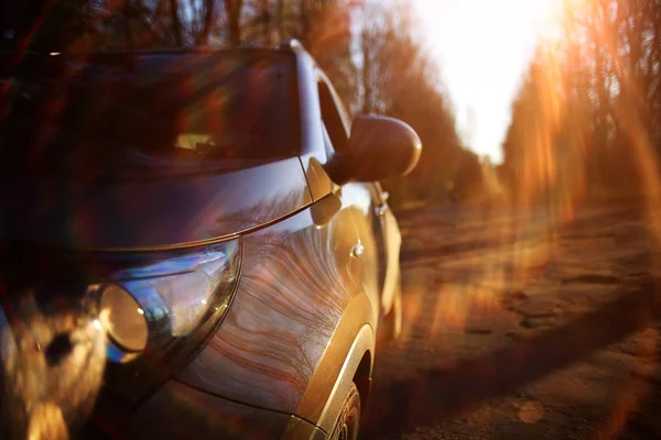 Car on autumn sunny road — Stock Photo, Image