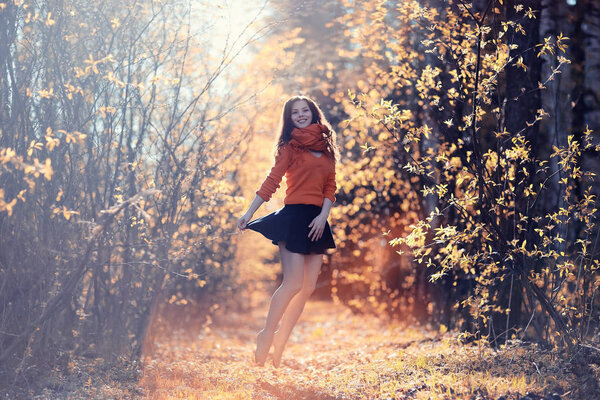Happy young woman jumping in spring forest, outdoor