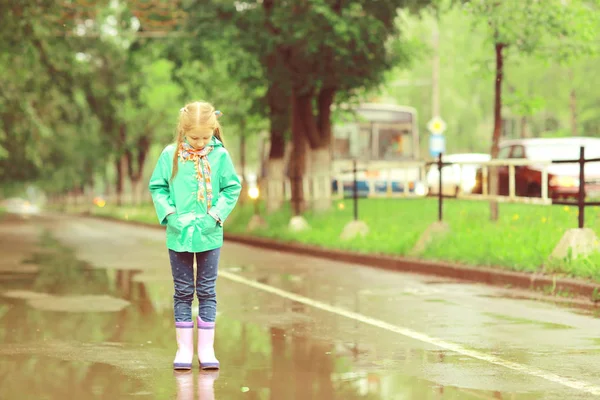 Girl playing outdoor after rain — Stock Photo, Image