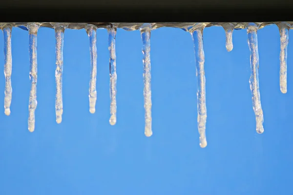 Icicles over blue clear sky — Stock Photo, Image