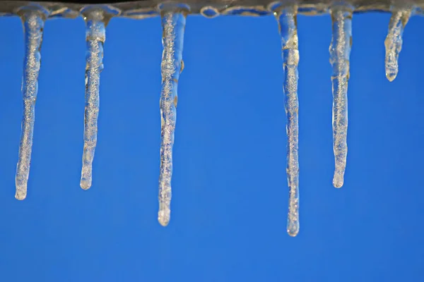 Icicles over blue clear sky — Stock Photo, Image