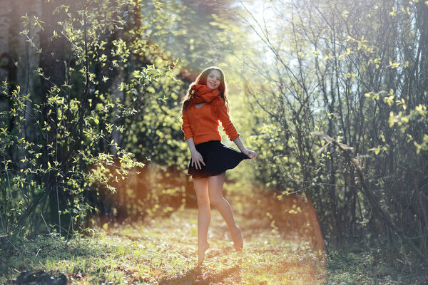 Cheerful and happy young girl posing in the spring forest, outdoor