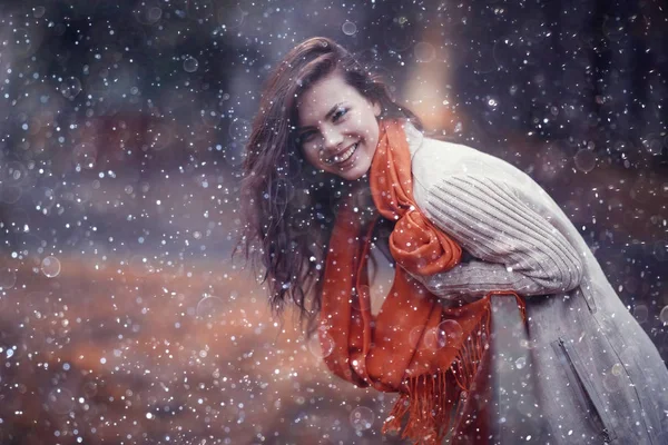 Jeune fille avec des flocons de neige dans l'air — Photo