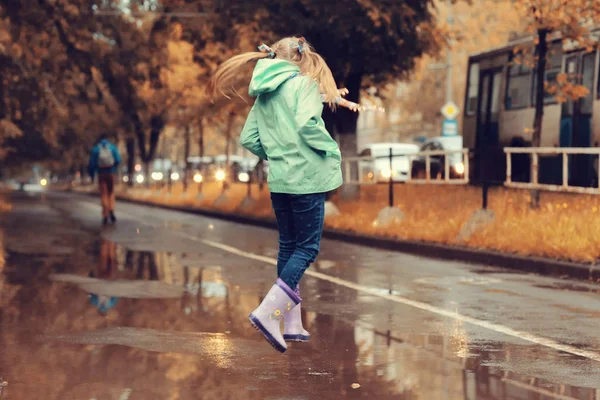 Chica jugando al aire libre después de la lluvia — Foto de Stock