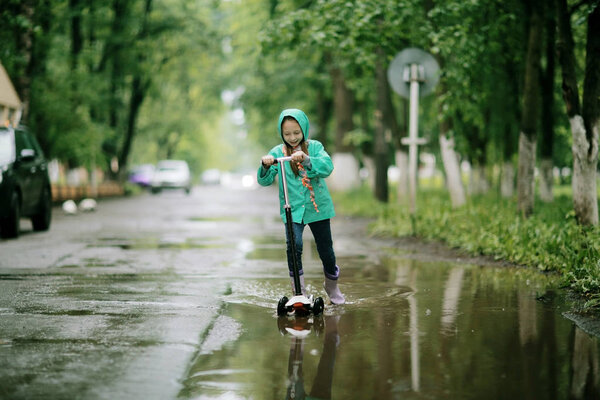 cute girl under Spring rain