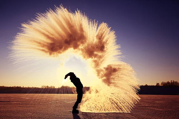 Man throwing snow at sunset — Stock Photo, Image