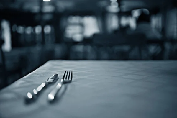 Serving cutlery on tablecloth — Stock Photo, Image