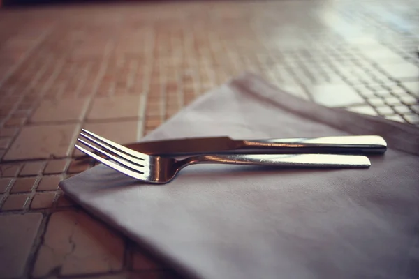 Serving cutlery on tablecloth — Stock Photo, Image