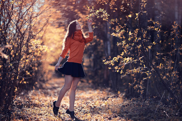 Portrait of cheerful girl in autumn park, outdoor