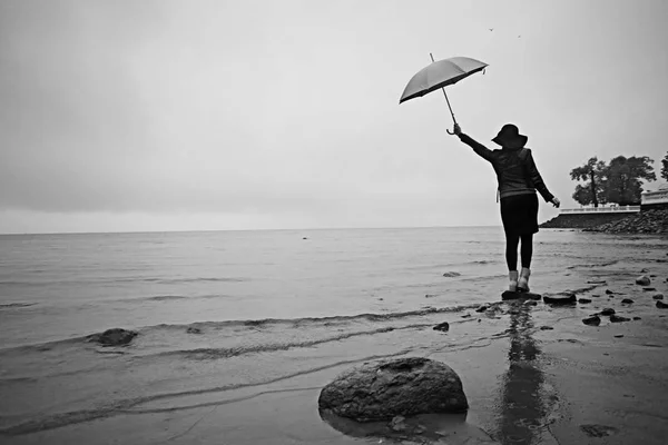 Женщина с зонтиком у моря — стоковое фото