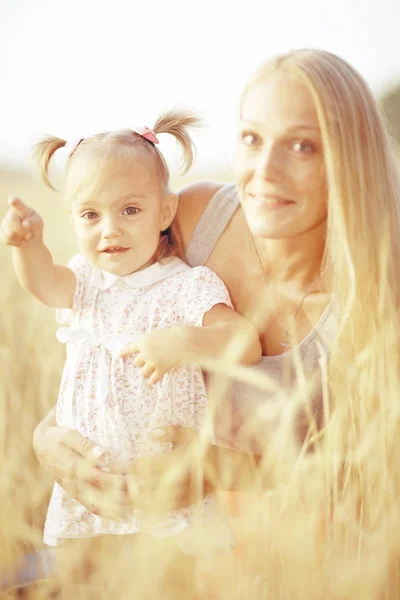 mother hugging daughter in field