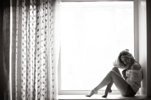 Young woman lying on a window — Stock Photo, Image