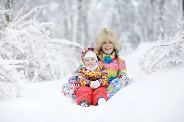 Kvinna och ett barn leker på vintern — Stockfoto