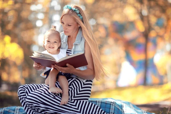 Mom reading a book to daughter