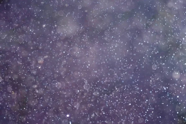 Textur von Schneeflocken auf verschwommenem Hintergrund — Stockfoto