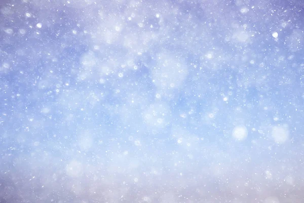 Konsistens av snöflingor på suddig bakgrund — Stockfoto