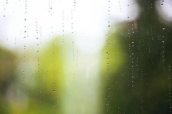Gotas de lluvia que fluyen por el vidrio —  Fotos de Stock