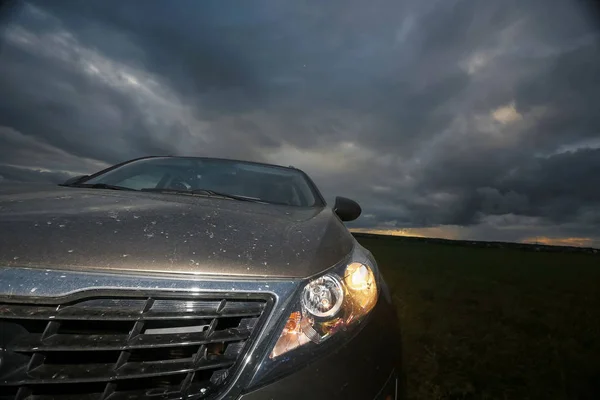 Car on the road in the field — Stock Photo, Image