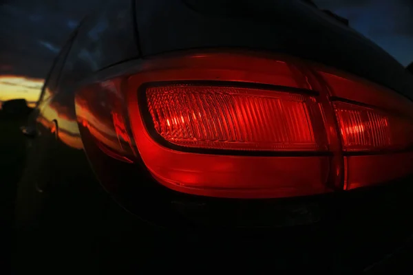 Car in the field at sunset — Stock Photo, Image