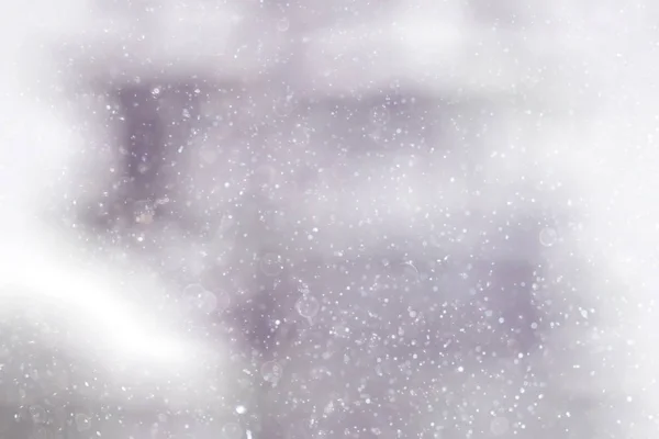 Konsistens av snöflingor på suddig bakgrund — Stockfoto