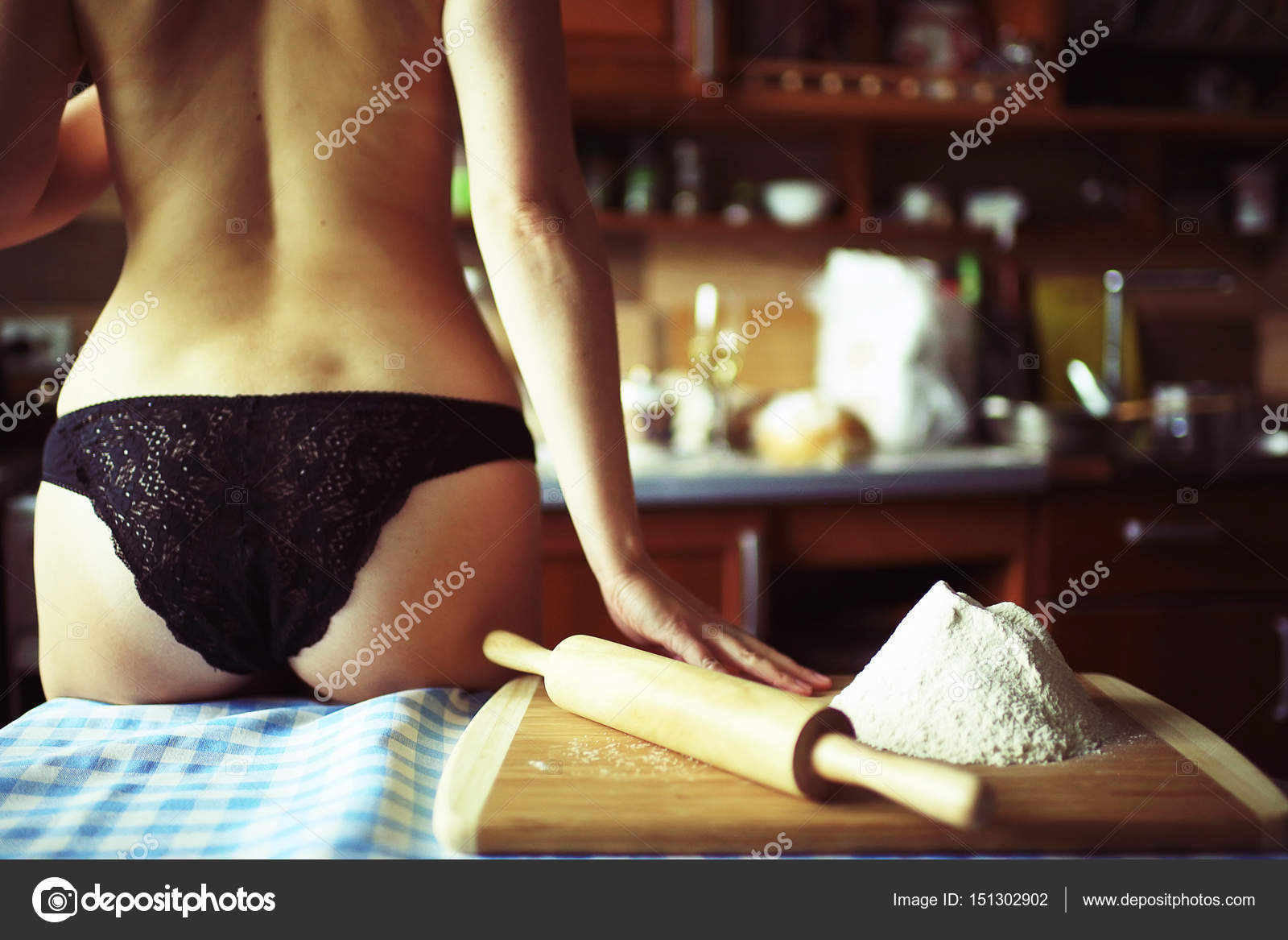 Girlfriend cooking breakfast in thong.