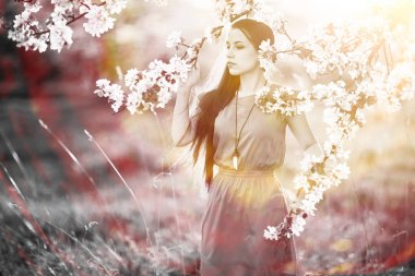 Bahar bahçesinde genç bir kadın 