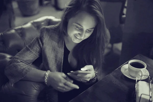 woman using smartphone in restaurant