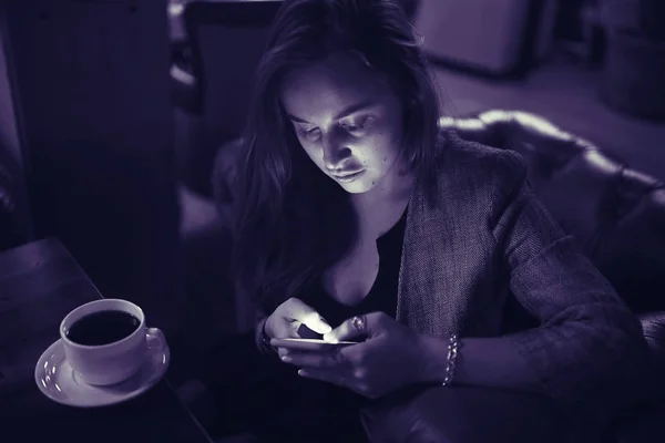 woman using smartphone in restaurant
