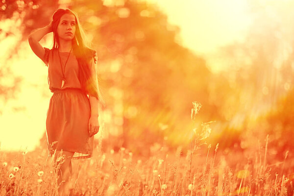 Portrait of young beautiful woman in picturesque field. Summer vacation and happiness concept