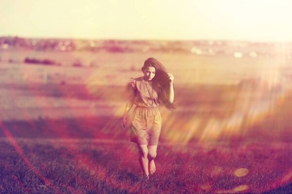 Portrait of young beautiful woman in rural field. Summer vacation and happiness concept