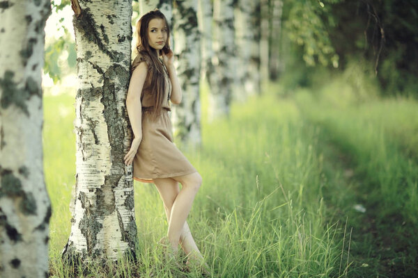 Portrait of young beautiful woman in rural field. Summer vacation and happiness concept