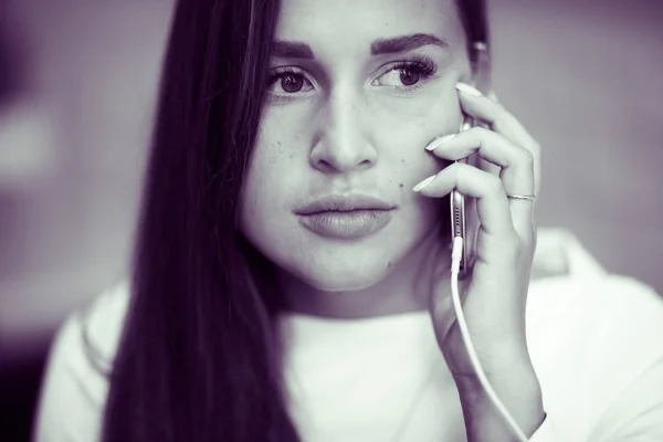 Ung kvinna pratar över mobiltelefon — Stockfoto