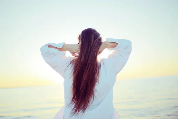 Girl with long hair at sea