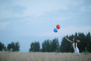 uçan balonlar ile buğday alan kadın