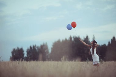 uçan balonlar ile buğday alan kadın