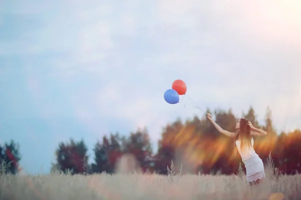 Donna in campo di grano con palloncini volanti — Foto Stock