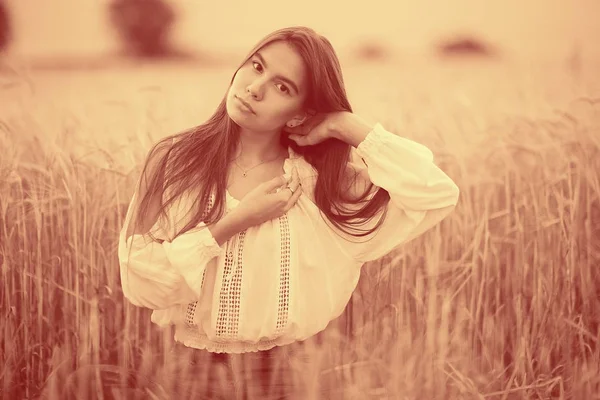 Young woman in wheaten field — Stock Photo, Image