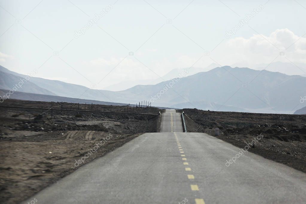 asphalt road in Tibetan plateau mountains, picturesque landscape