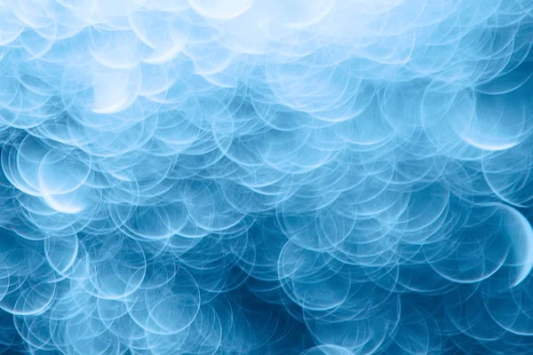 Mavi bokeh ışıkları ile soyut sihirli doku, fantezi arka plan bulanık.   