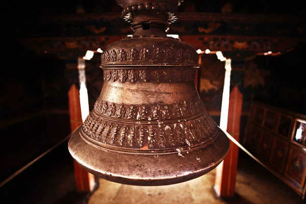 ancient metal bell with religious ornament on Tibetan temple