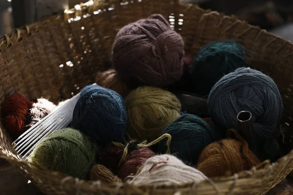 Different yarn in wicker basket — Stock Photo, Image