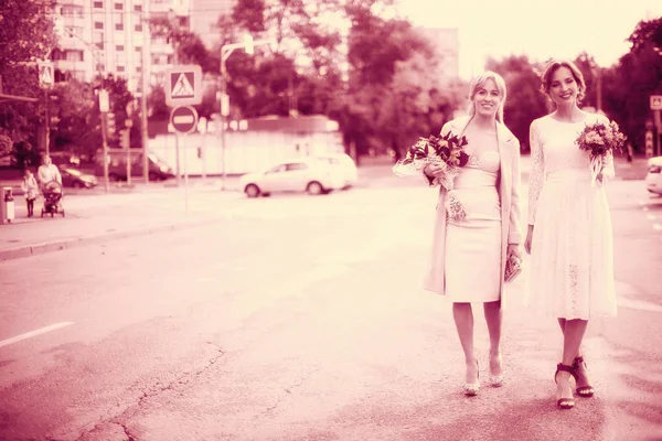 bride in wedding dress and bridesmaid