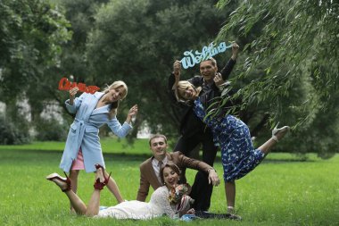 güzel genç nedime, mutlu gelin ve Damat Düğün gününde yaz parkta eğleniyor 