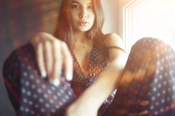 Young woman on windowsill — Stock Photo, Image