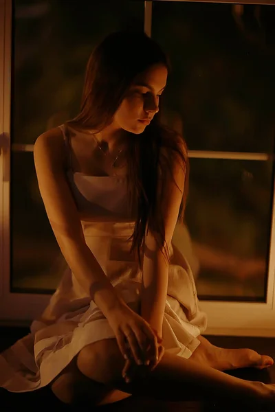 Young woman on windowsill — Stock Photo, Image