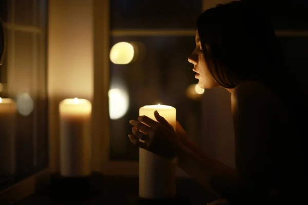 Woman with burning candles — Stock Photo, Image