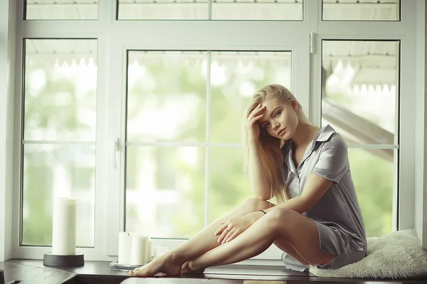 Young woman on windowsill — Stock Photo, Image
